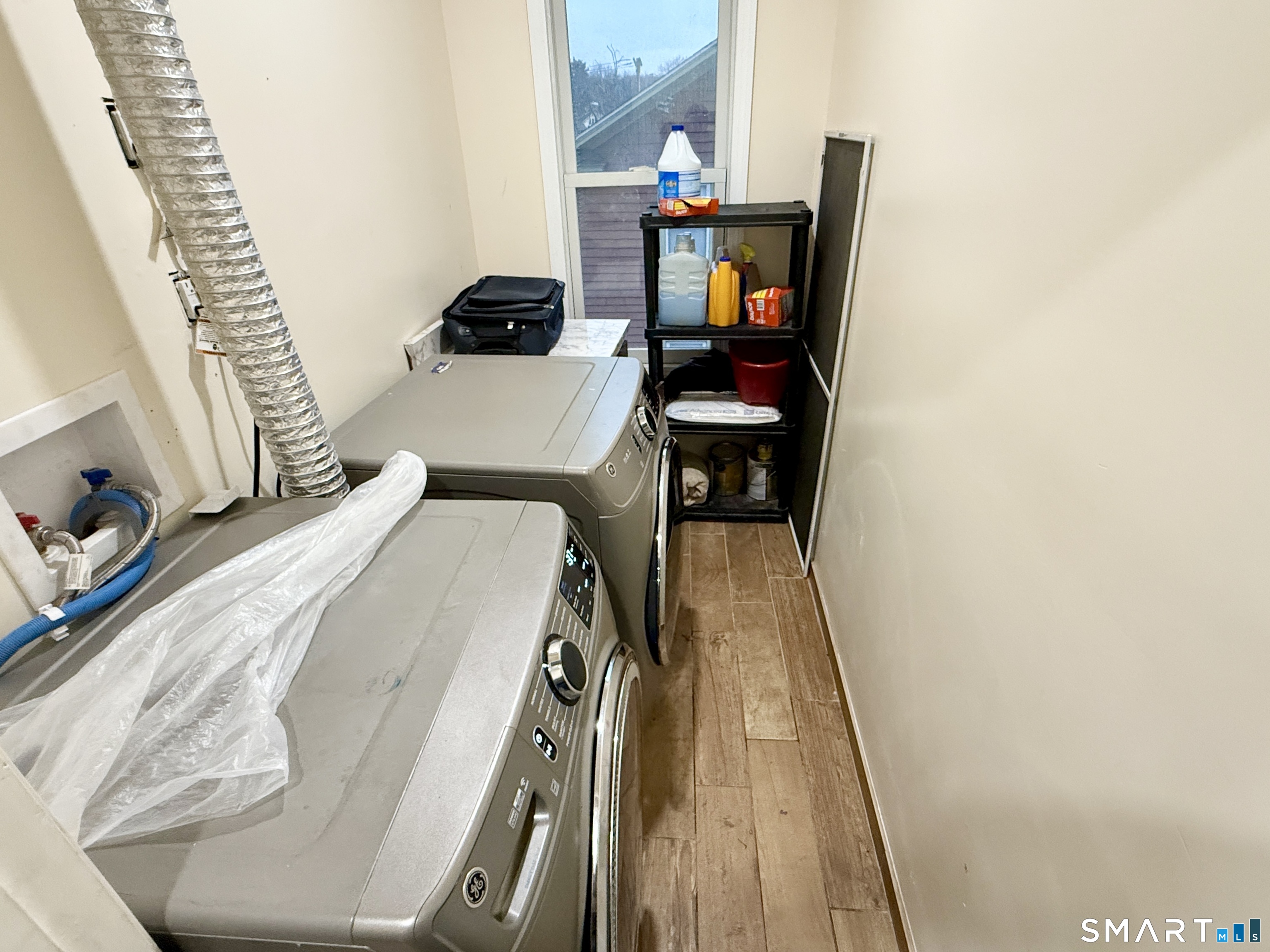 26 Victory Street Bridgeport, CT 06606 - Photo 21 of 32 a bedroom with a bed and a flat tv screen on a dresser