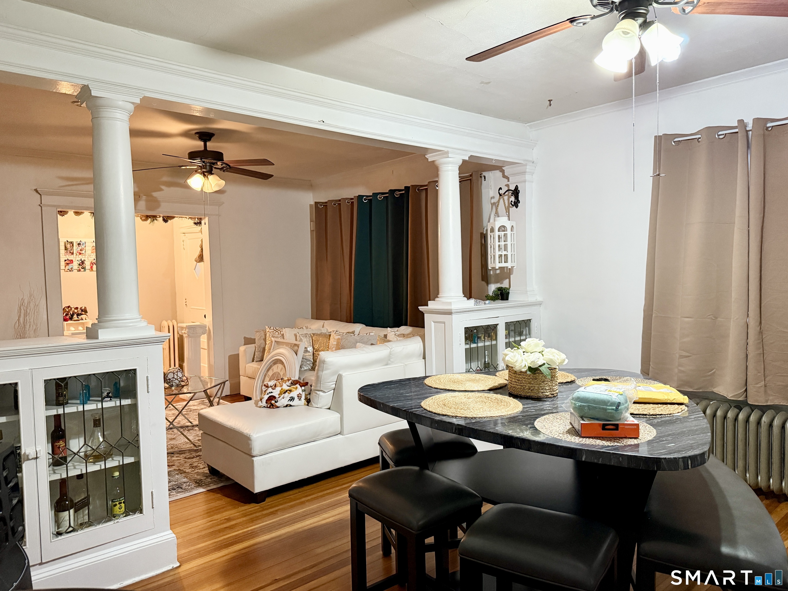 26 Victory Street Bridgeport, CT 06606 - Photo 7 of 32 a view of a dining room with furniture and wooden floor