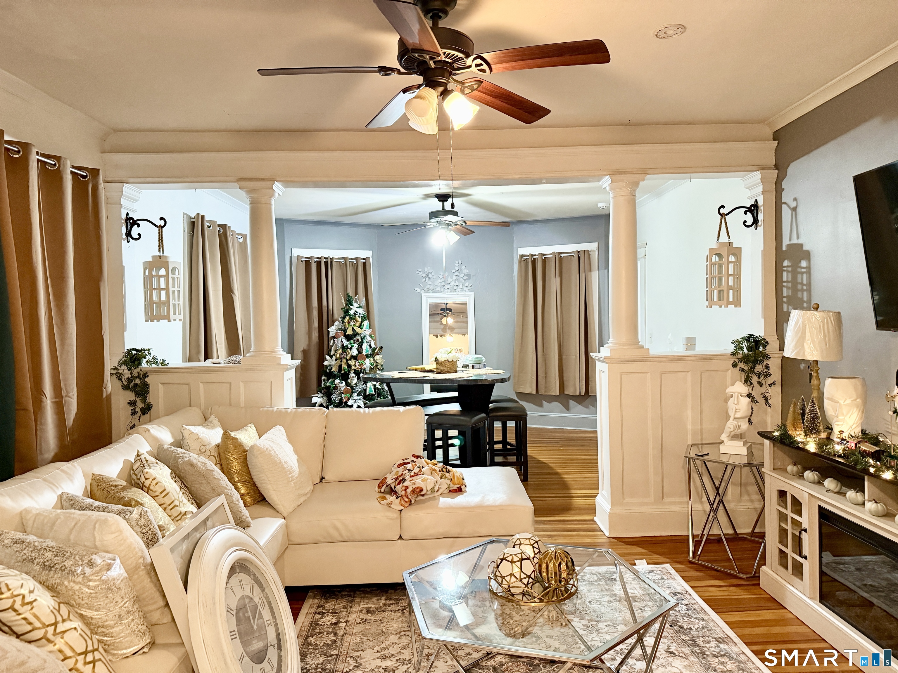 26 Victory Street Bridgeport, CT 06606 - Photo 8 of 32 a living room with furniture and a chandelier