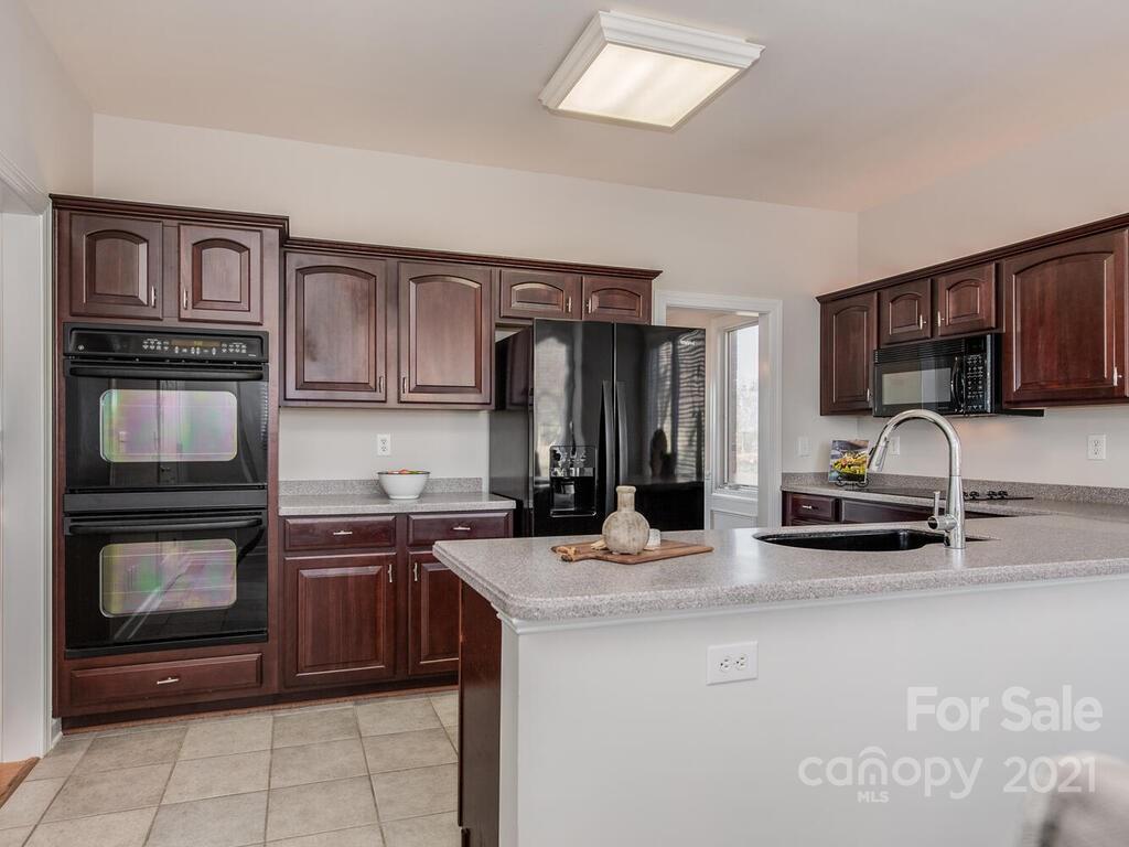 8683 Howard Drive Terrell, NC 28682 - Photo 20 of 46 a kitchen with kitchen island granite countertop a stove sink and microwave