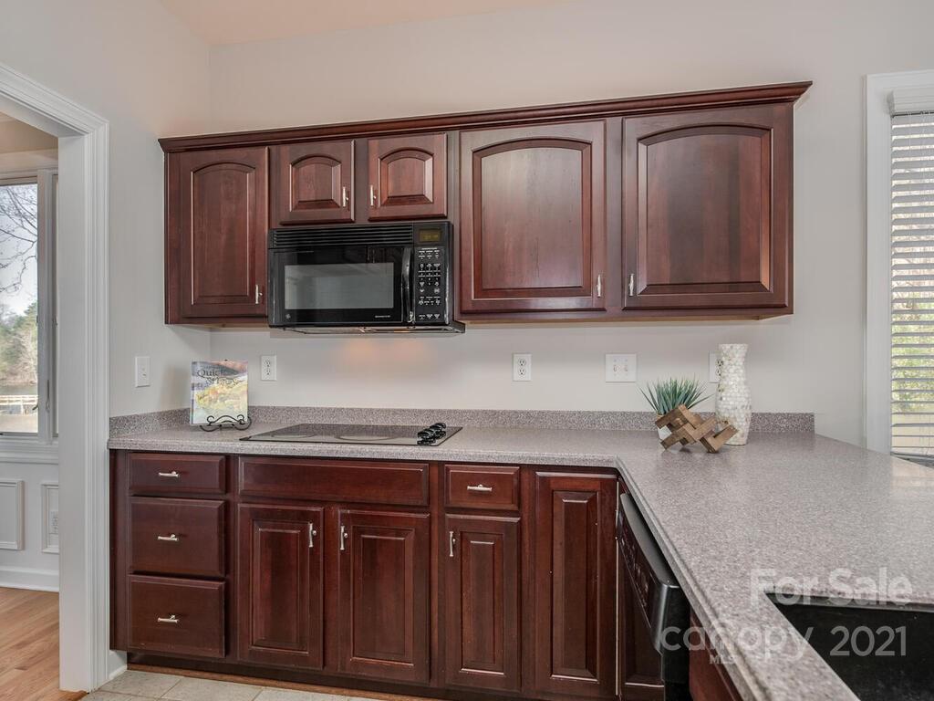 8683 Howard Drive Terrell, NC 28682 - Photo 22 of 46 a kitchen with granite countertop a cabinets and black appliances