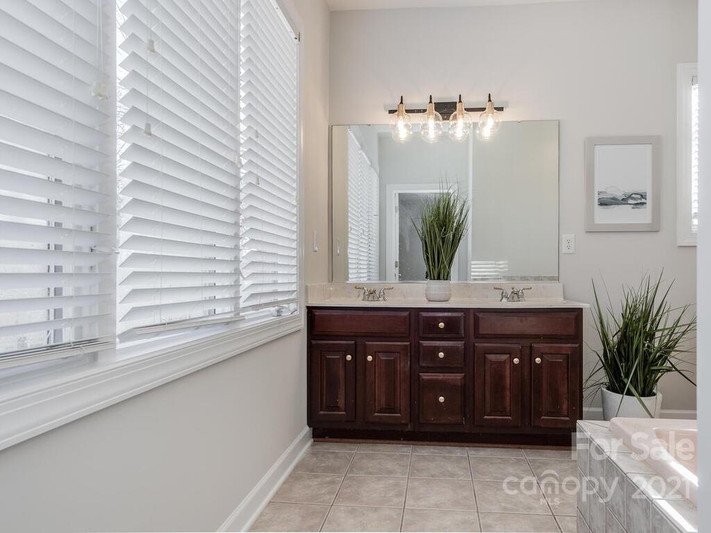 8683 Howard Drive Terrell, NC 28682 - Photo 24 of 46 a bathroom with a sink and a large mirror