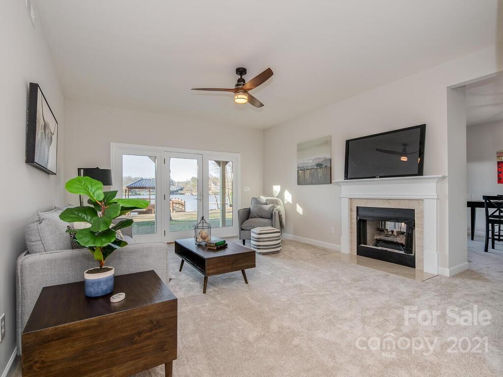 8683 Howard Drive Terrell, NC 28682 - Photo 30 of 46 a living room with furniture a fireplace and a flat screen tv