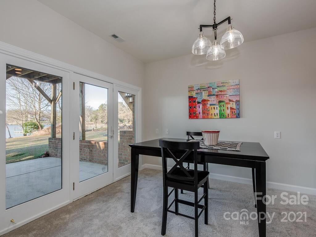 8683 Howard Drive Terrell, NC 28682 - Photo 35 of 46 a view of a dining room with furniture wooden floor and a chandelier