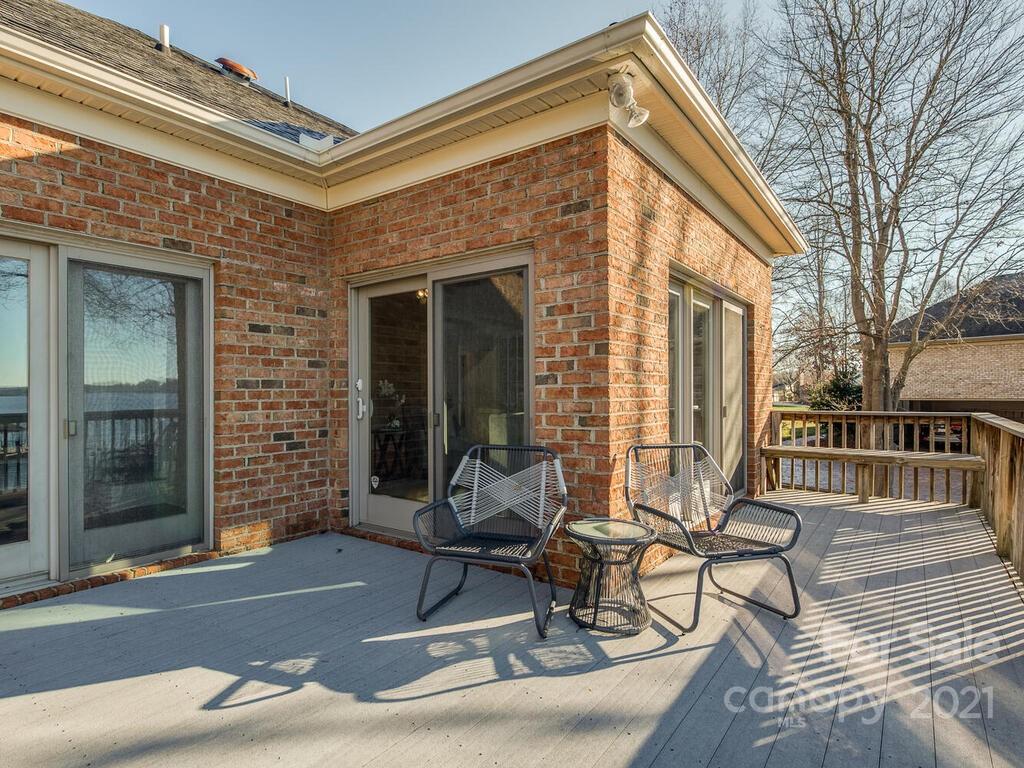 8683 Howard Drive Terrell, NC 28682 - Photo 39 of 46 a view of a brick house with chairs and table in a patio