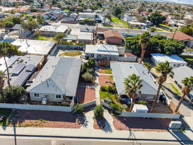 an aerial view of residential houses with outdoor space