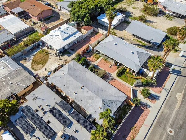 an aerial view of a house with a yard