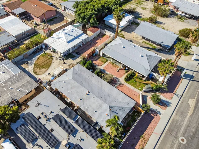 an aerial view of a house with a yard