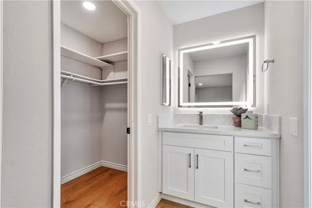 a bathroom with a granite countertop sink mirror and