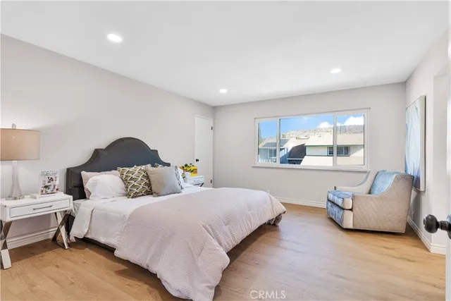 a spacious bedroom with a bed and a couch