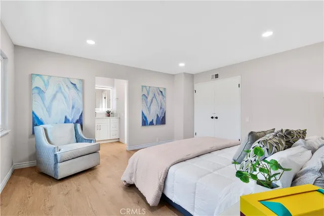 a spacious bedroom with a bed and a couch