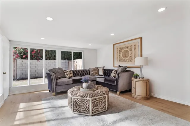 a living room with furniture a lamp and a window