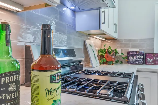 a stove top oven sitting inside of a kitchen