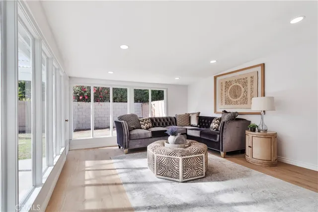 a living room with furniture and a painting on the wall