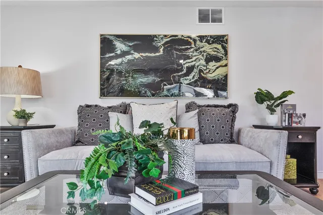 a living room with furniture and a potted plant