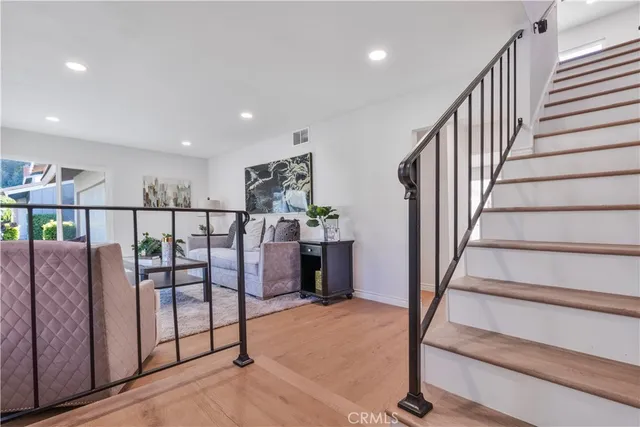 a view of a livingroom with furniture stairs and a couch