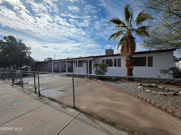 a palm tree in front of a house