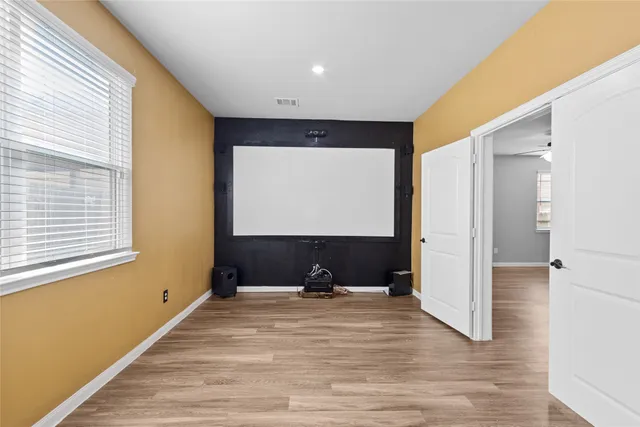 a room with a large window and a wooden floor