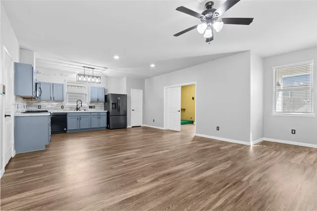 a view of a kitchen with a sink and a refrigerator