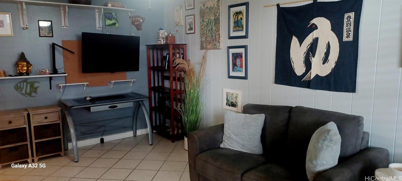 423 Kaiolu Street, Unit 106 Honolulu, HI 96815 - Photo 11 of 25 a living room with furniture and a flat screen tv