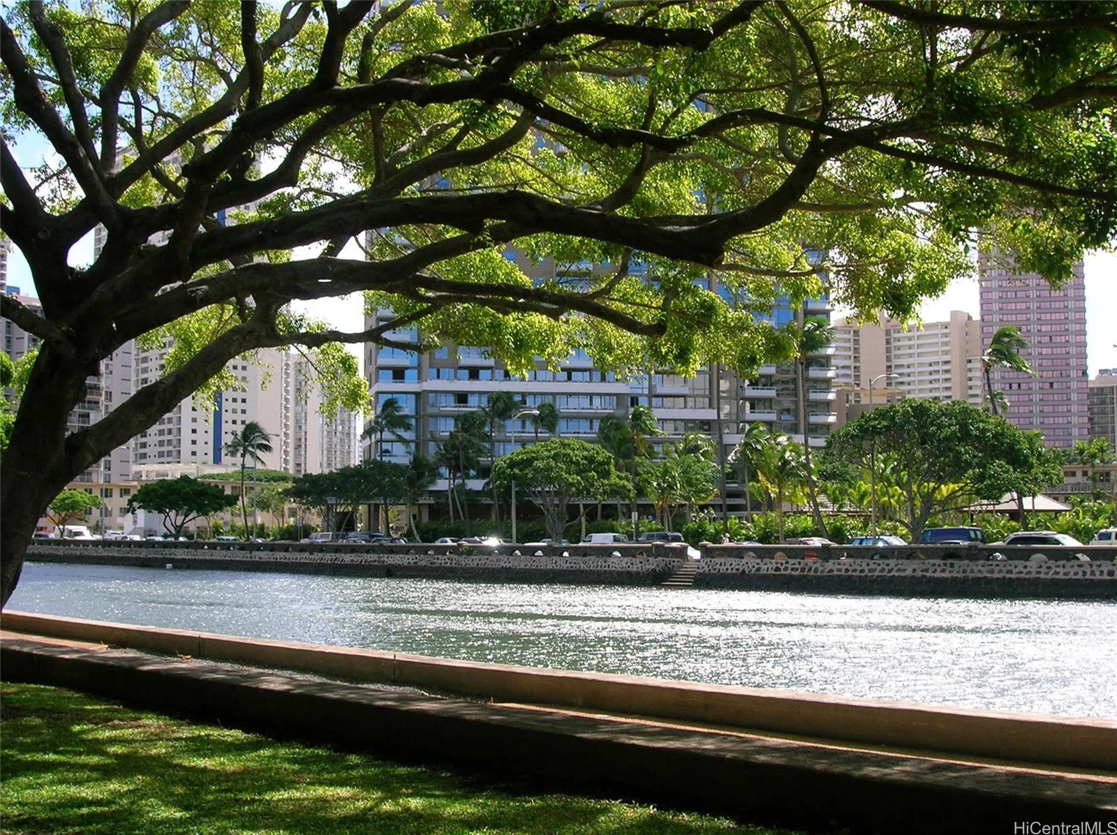 423 Kaiolu Street, Unit 106 Honolulu, HI 96815 - Photo 24 of 25 a front view of a house with a garden and a tree