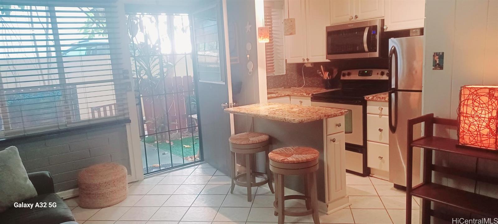423 Kaiolu Street, Unit 106 Honolulu, HI 96815 - Photo 9 of 25 a kitchen with a sink a stove and a refrigerator