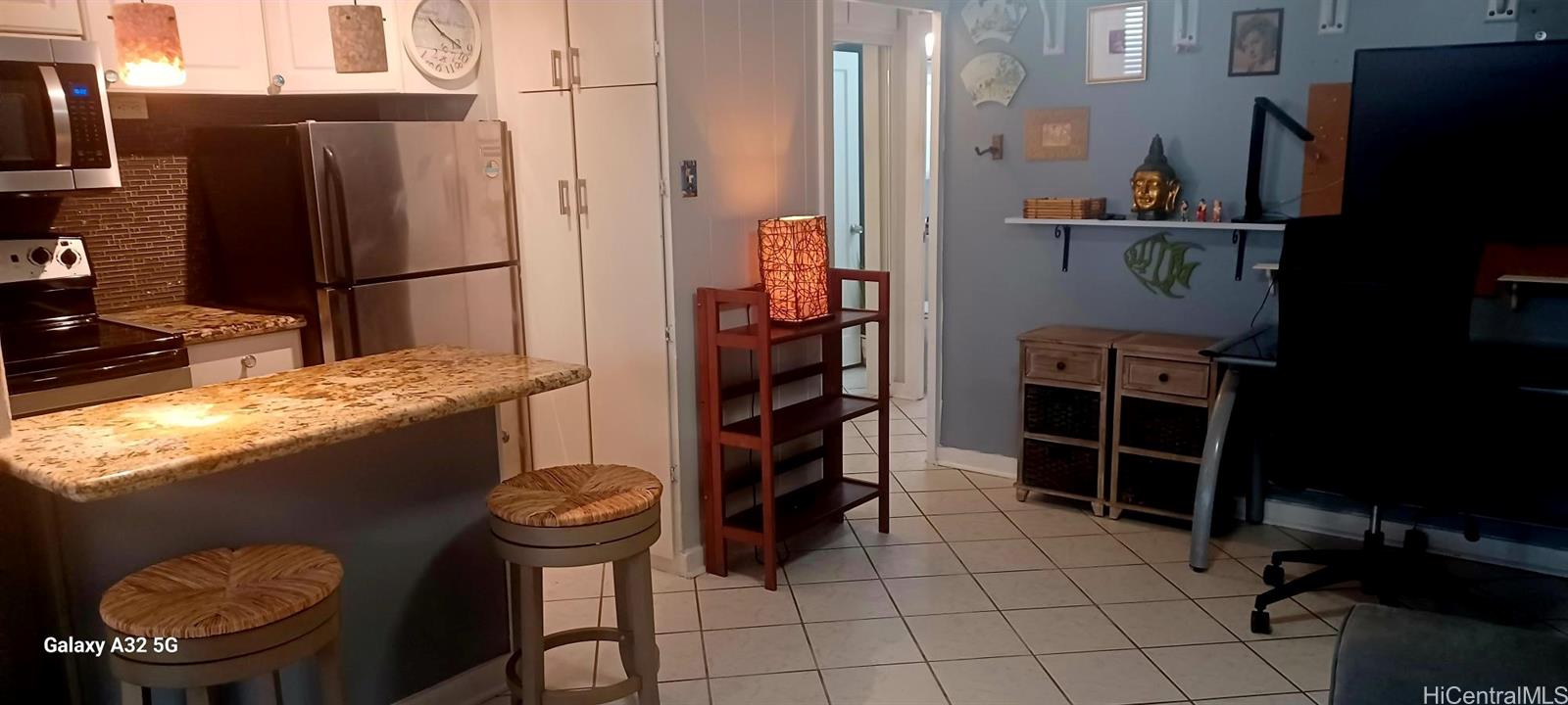 423 Kaiolu Street, Unit 106 Honolulu, HI 96815 - Photo 10 of 25 a kitchen with stainless steel appliances granite countertop a refrigerator and a stove