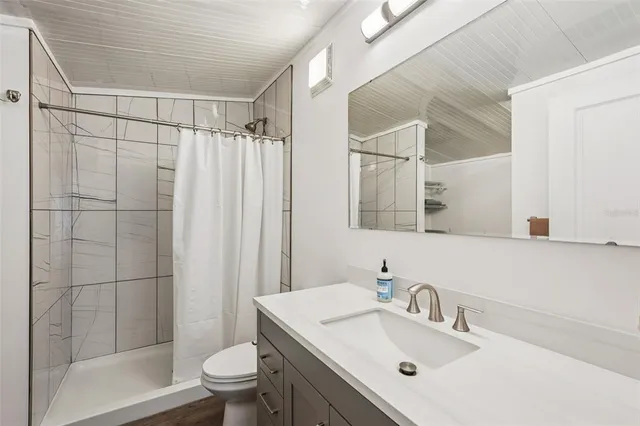 a bathroom with a sink toilet and shower