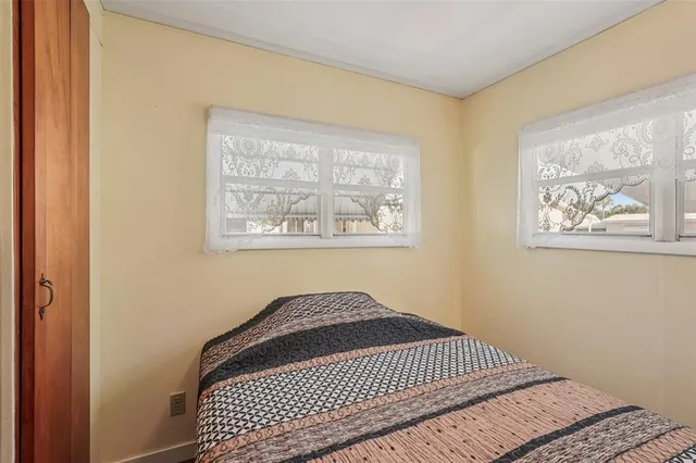 a view of a bedroom with wooden floor