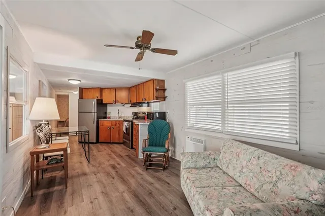 a living room with furniture and kitchen view
