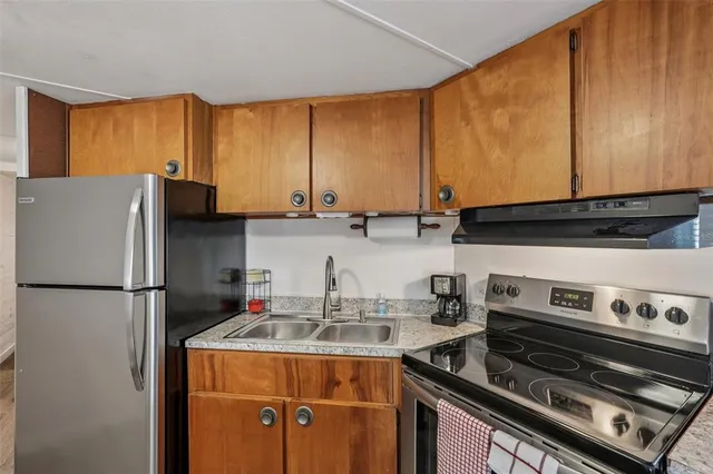 a kitchen with stainless steel appliances a refrigerator a stove and a sink