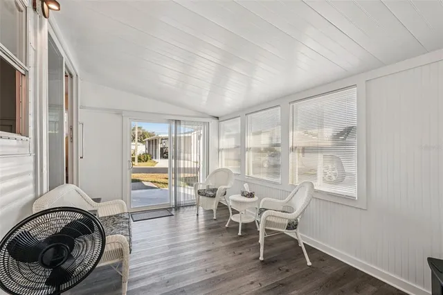 a living room with furniture and a floor to ceiling window