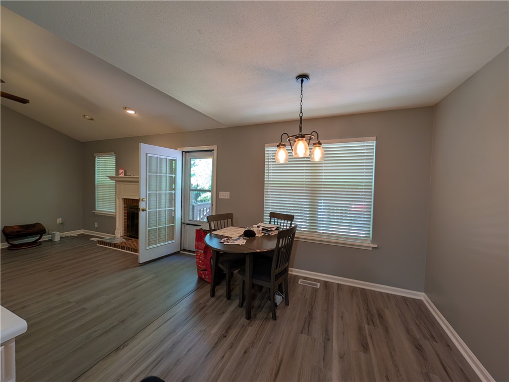 124 Woodbridge Court Anderson, SC 29621 - Photo 15 of 15 This inviting space features a fireplace, durable flooring, and direct outdoor access, ideal for daily living.