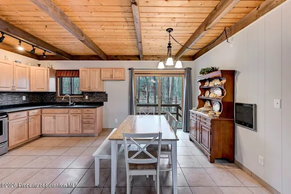 a kitchen with stainless steel appliances granite countertop a stove a sink dishwasher and cabinets with wooden floor
