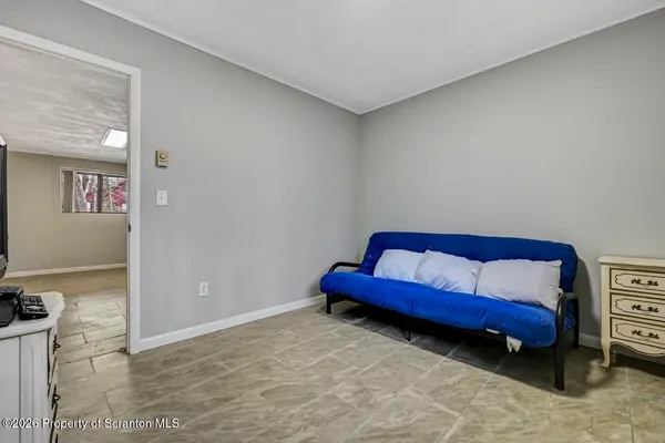 a living room with window and a flat screen tv
