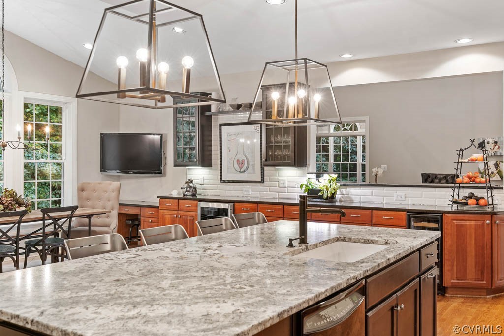 14837 Felbridge Way Midlothian, VA 23113 - Photo 16 of 50 a kitchen with stainless steel appliances kitchen island granite countertop a table chairs in it and wooden floors