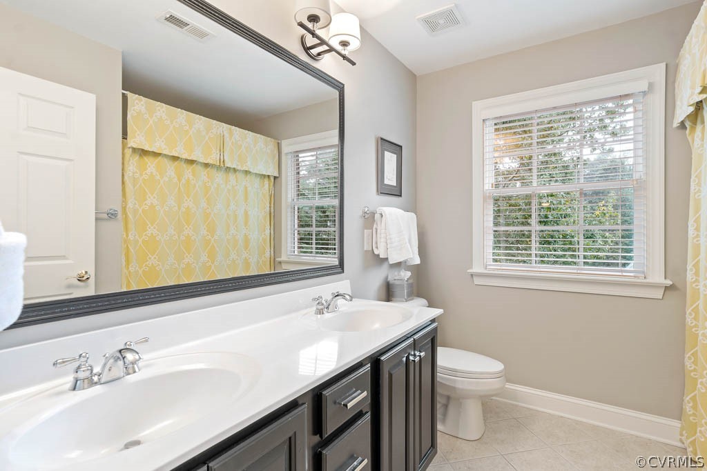 14837 Felbridge Way Midlothian, VA 23113 - Photo 26 of 50 a bathroom with a sink a toilet and a large mirror