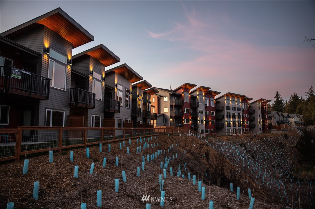 1882 Front Street, Unit 404 Lynden, WA 98264 - Photo 16 of 18 a view of a house with many windows and a yard