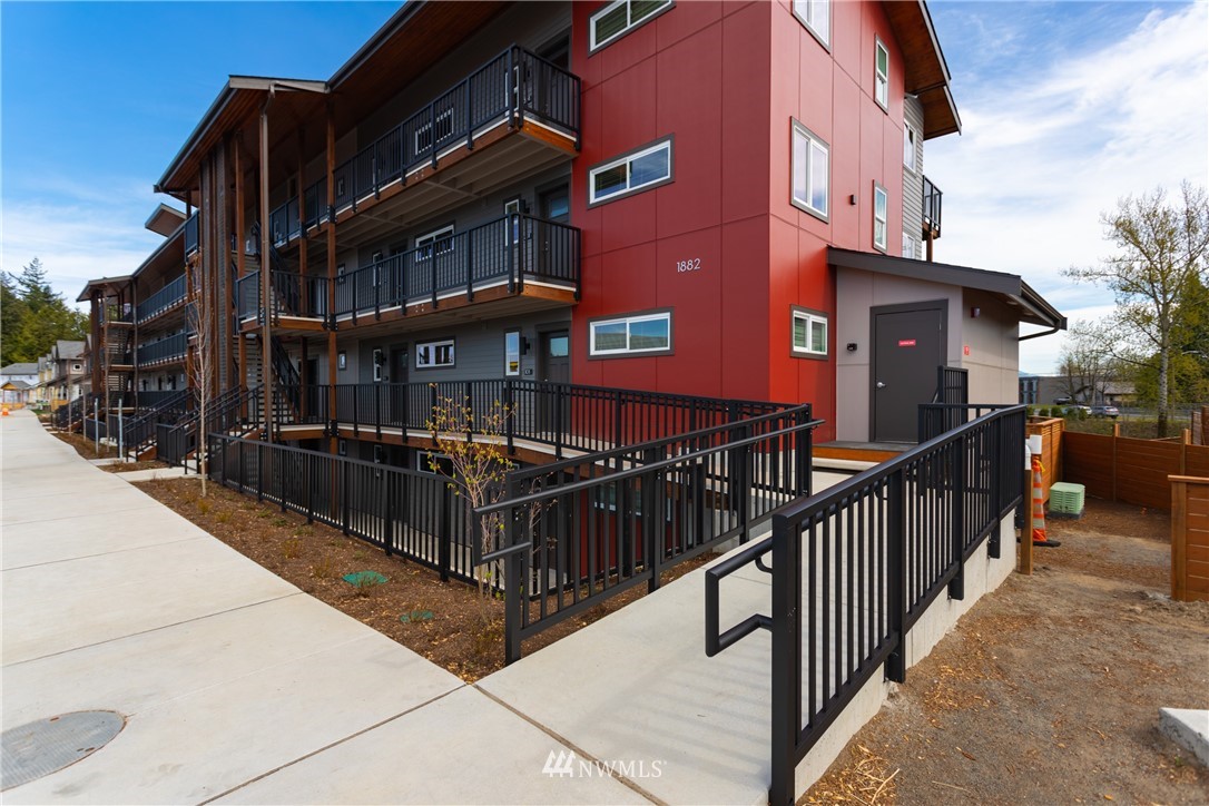 1882 Front Street, Unit 404 Lynden, WA 98264 - Photo 5 of 18 a view of a house with wooden fence