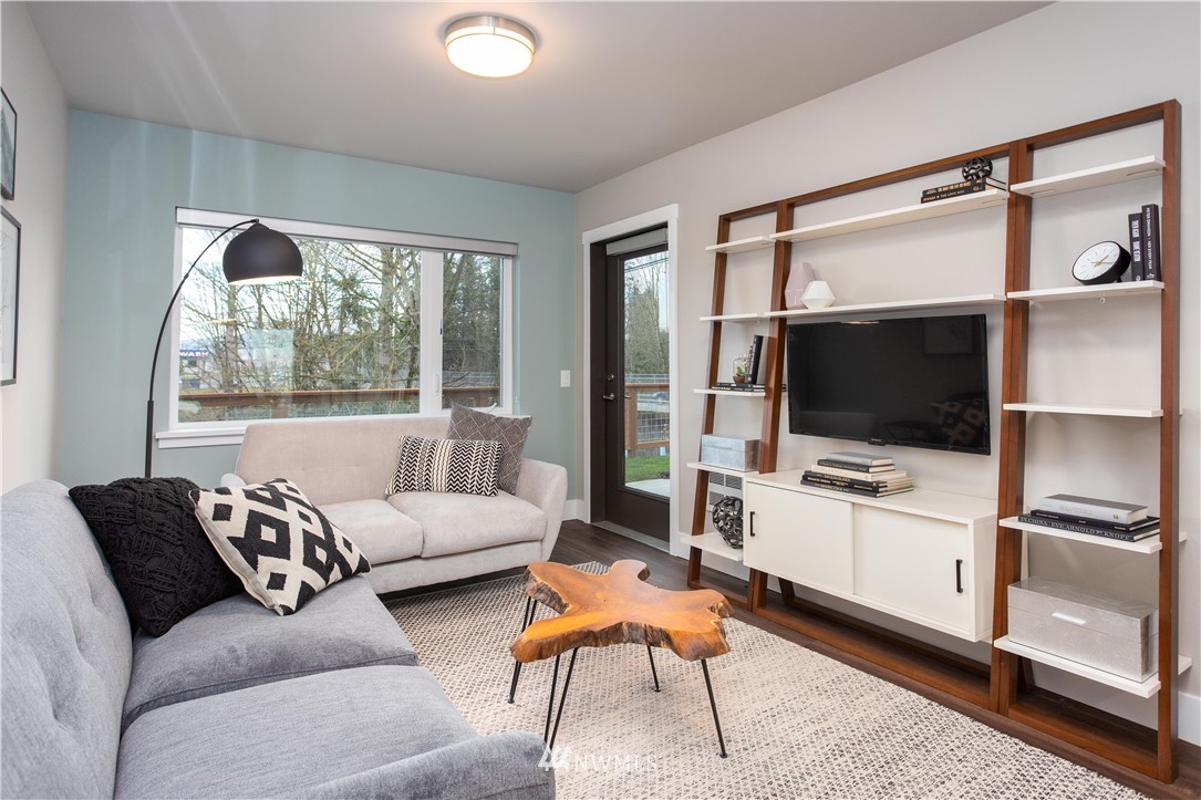1882 Front Street, Unit 404 Lynden, WA 98264 - Photo 7 of 18 a living room with furniture and a flat screen tv