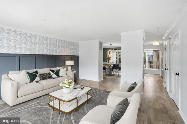 a living room with furniture a wooden floor and a chandelier