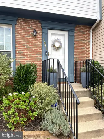 a view of a balcony with flower plants