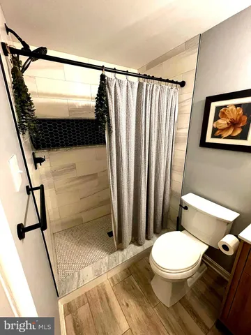a bathroom with a toilet and a shower