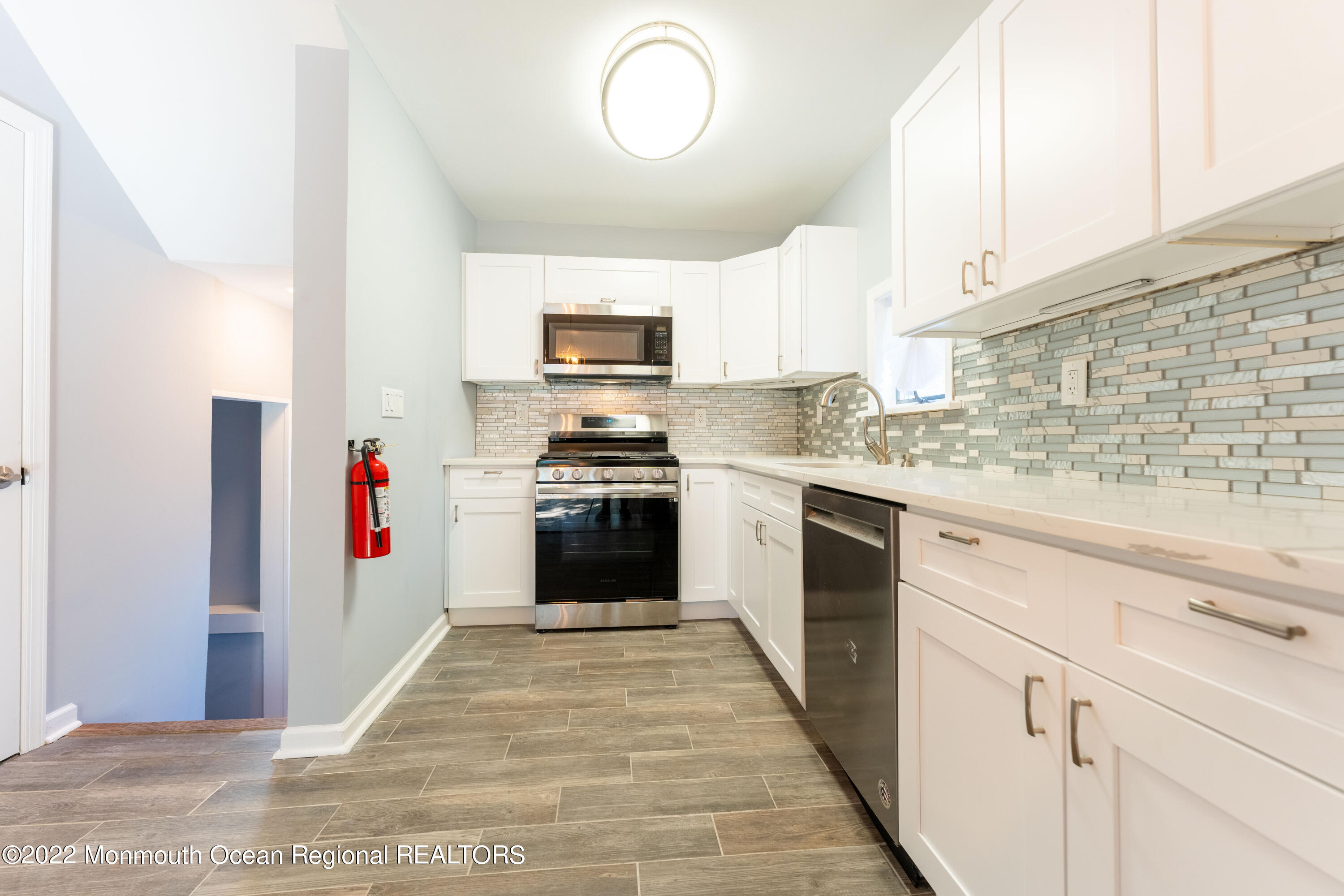 397 E Road Belford, NJ 07718 - Photo 12 of 34 a kitchen with cabinets a sink and white appliances