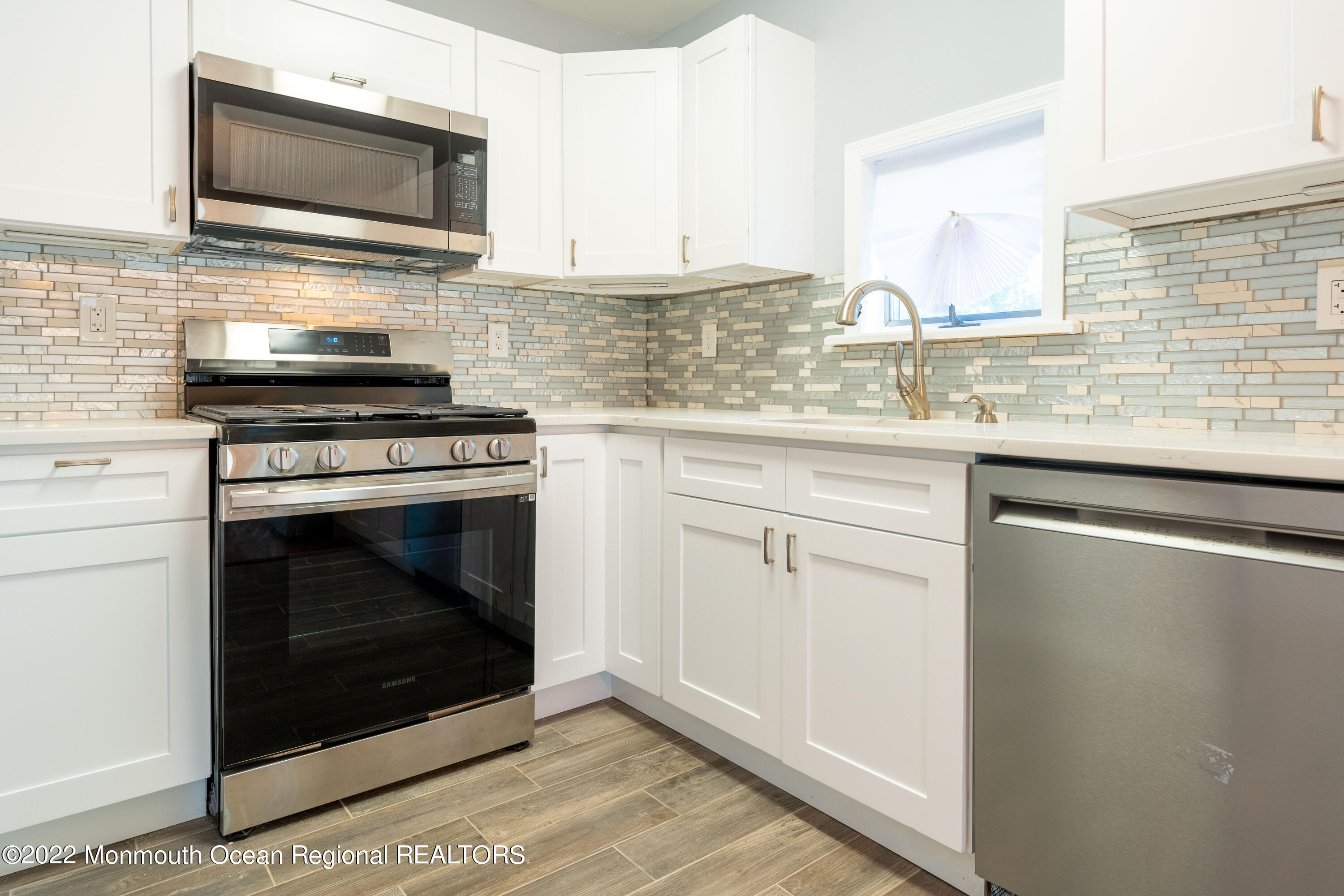397 E Road Belford, NJ 07718 - Photo 14 of 34 a kitchen with stainless steel appliances granite countertop a stove microwave and sink