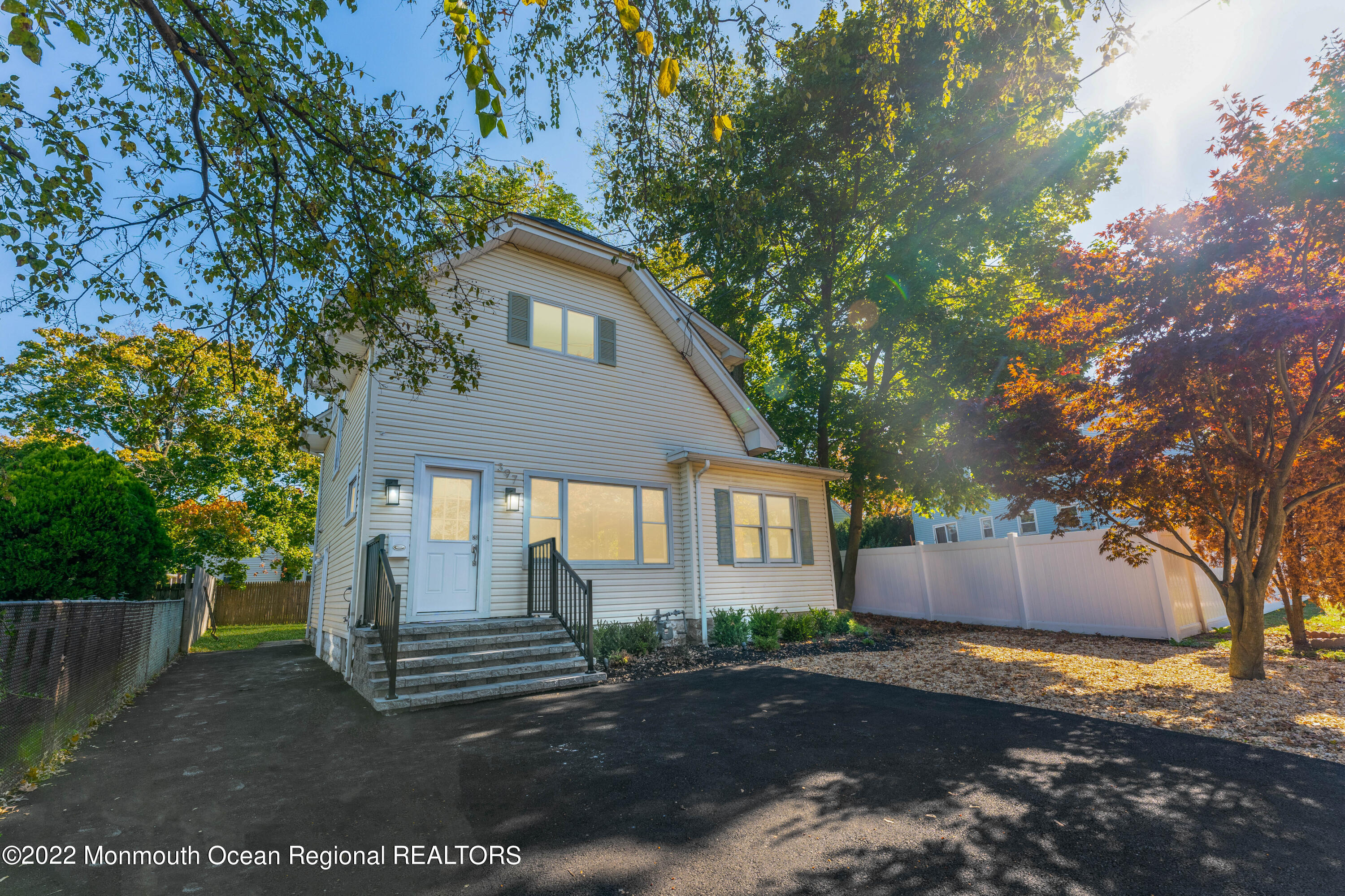 397 E Road Belford, NJ 07718 - Photo 2 of 34 a front view of a house with a yard and garage