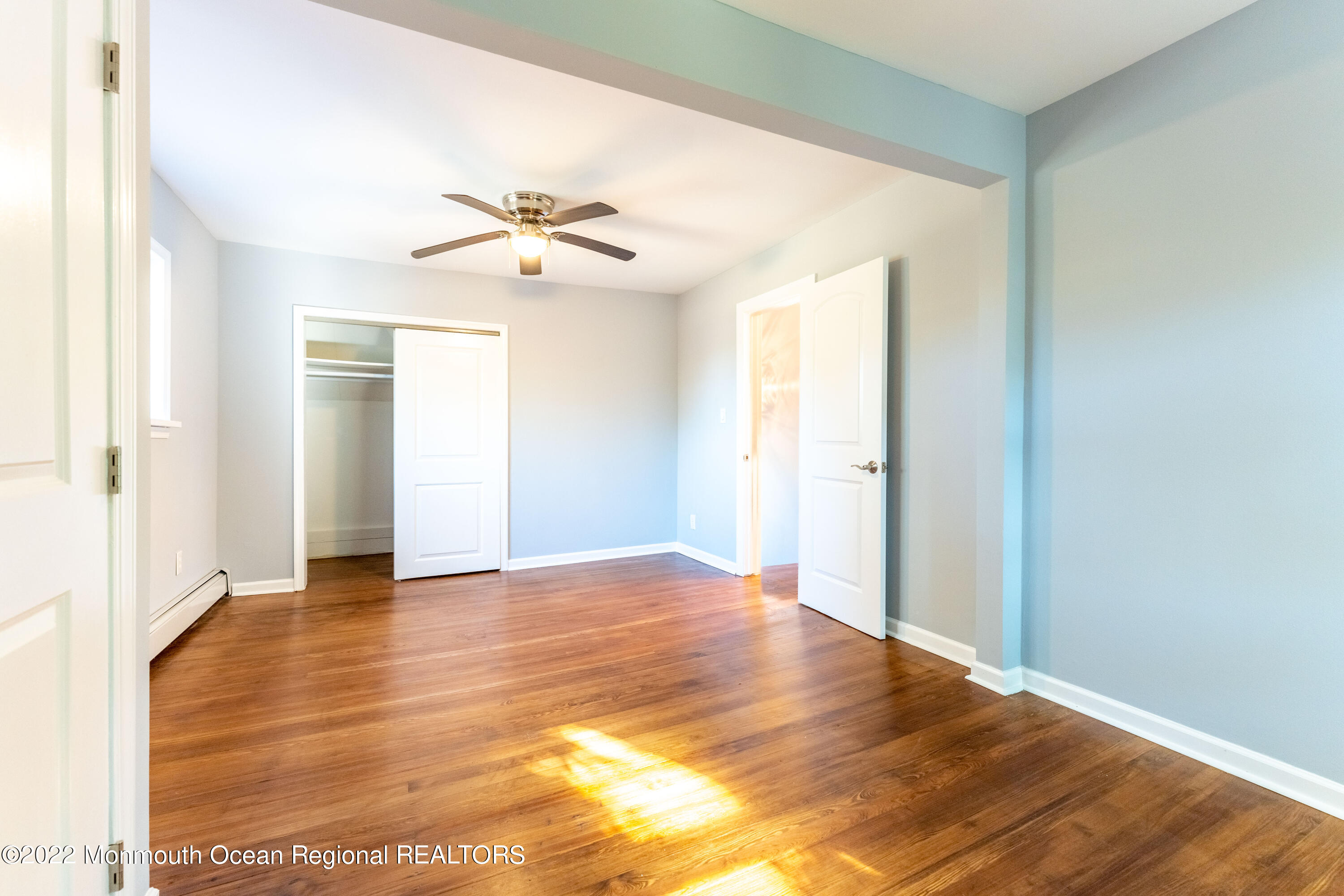 397 E Road Belford, NJ 07718 - Photo 21 of 34 a view of an empty room with window and wooden floor