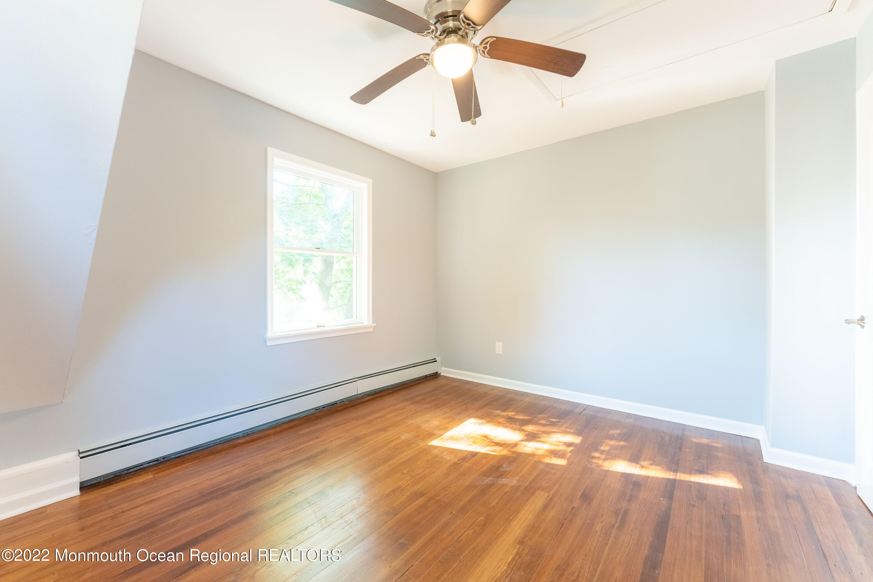397 E Road Belford, NJ 07718 - Photo 24 of 34 an empty room with a window and a ceiling fan