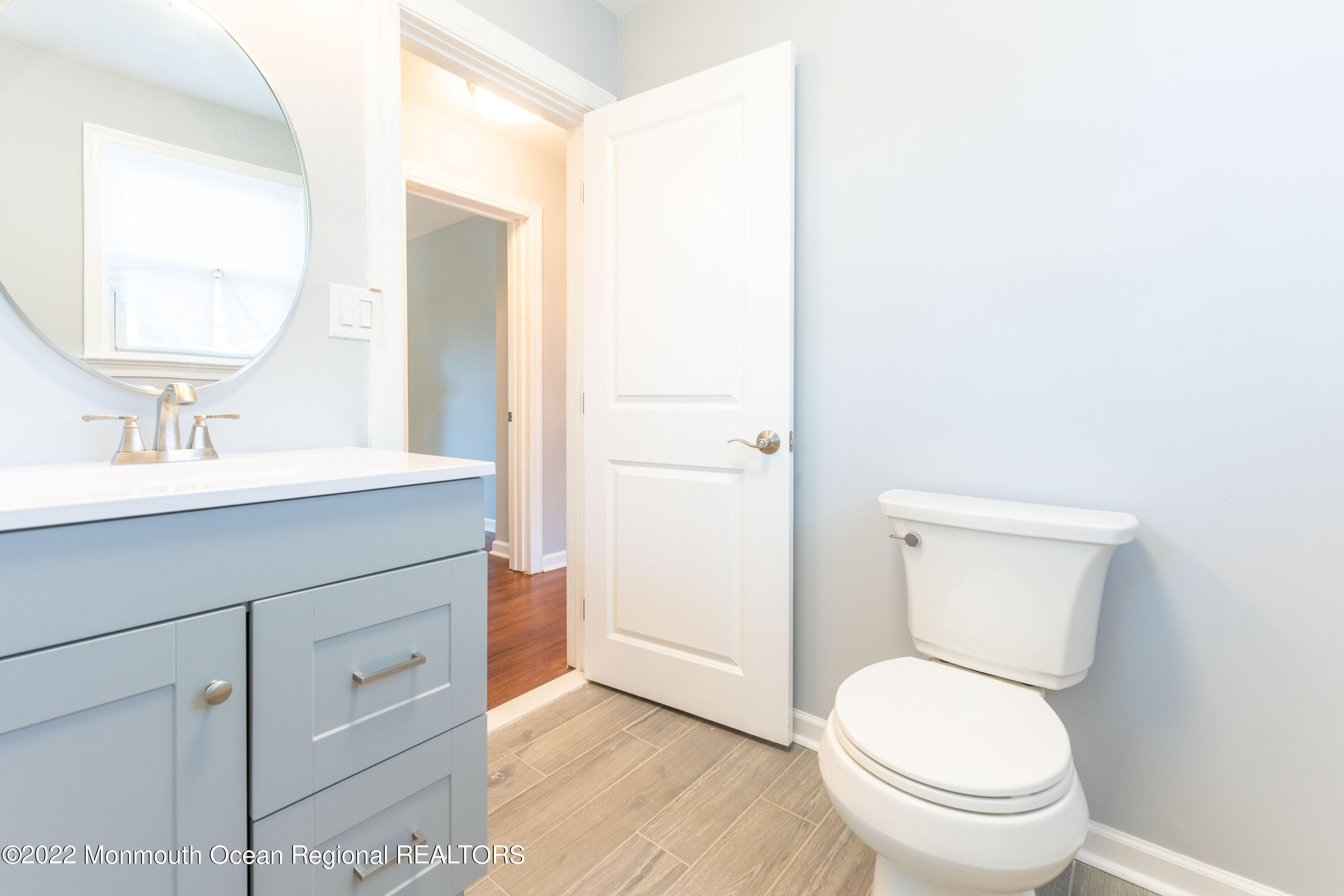 397 E Road Belford, NJ 07718 - Photo 28 of 34 a bathroom with a toilet a sink and mirror