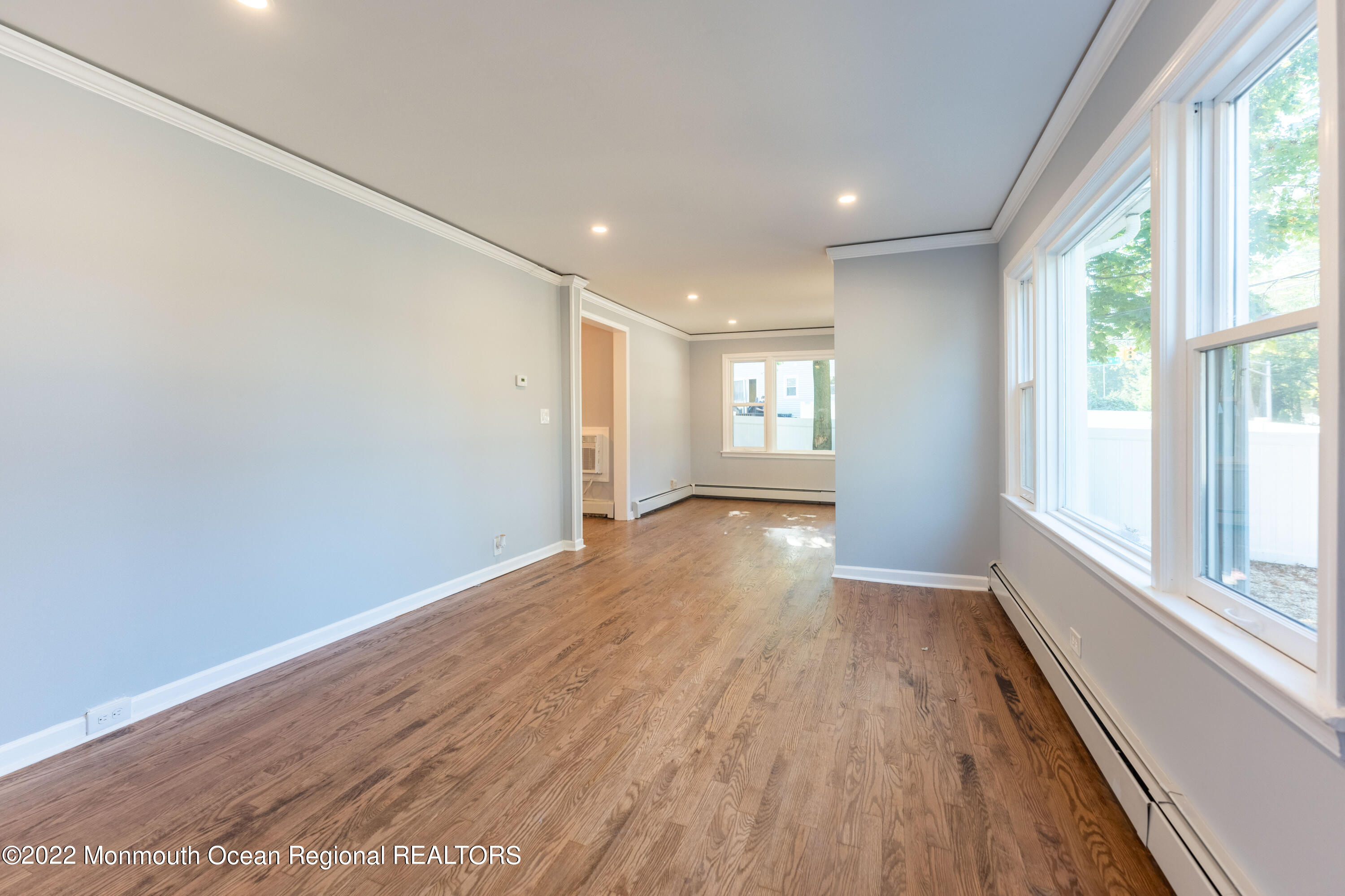 397 E Road Belford, NJ 07718 - Photo 4 of 34 an empty room with wooden floor and windows